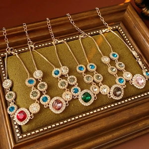 Detail view of five luxury crystal bracelets in various colors on a vintage display