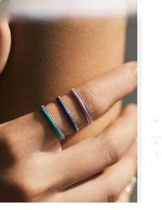 Detail of three stacked S925 silver rings with colorful enamel and pavé diamonds