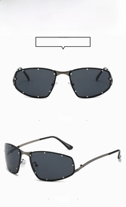Close-up of gunmetal square sunglasses with silver stud accents and grey lenses