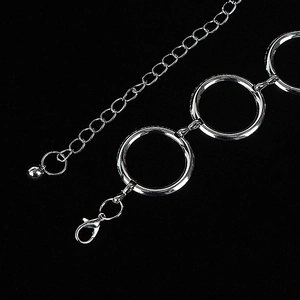 Silver metal waist chain belt featuring large circular rings and adjustable lobster clasp