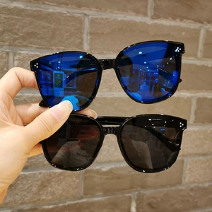 Detail shot of vintage oversized kids sunglasses with blue and black lenses and silver rivets