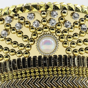 Detailed macro view of luxury gold captain hat featuring intricate rhinestones and studs