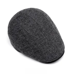 Top view detail of dark gray wool knit beret showing high-quality fabric texture