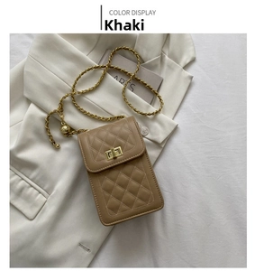 Detailed close-up of khaki quilted phone bag with gold chain strap on white fabric