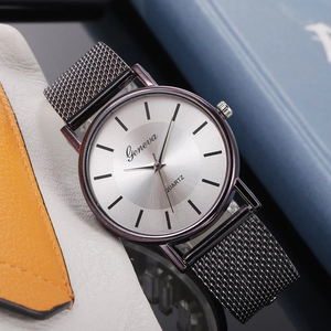 Detailed close-up of a Geneva quartz watch featuring a black Milanese mesh strap and silver dial