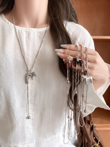 Detailed view of horse pendants on snake chains in silver, black, and brown finishes