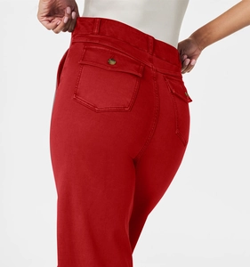Detail view of red casual trousers showing rear flap pocket with button and fine stitching