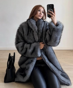 Detailed texture of grey faux fox fur coat with long sleeves and shawl collar