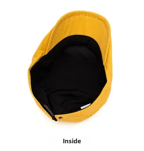 Detail of yellow flat cap interior showing black breathable lining and sweatband