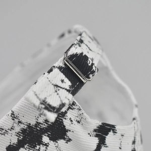 Detail of adjustable silver metal buckle and tie-dye cotton fabric on sun visor hat