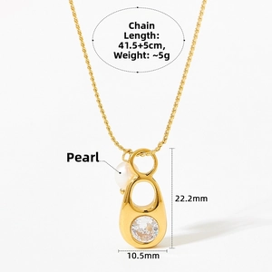 Detail of gold pull ring pendant with green zircon and pearl on stainless steel chain