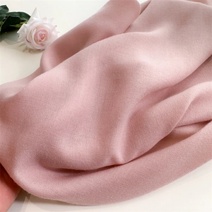 Close-up of pink cotton linen fabric showing soft texture and natural drape folds