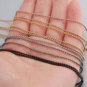 Hand holding stainless steel ball chain necklaces in gold, silver, black, and rose gold