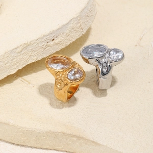 Detail view of organic textured gold and silver rings with dual zirconia stones