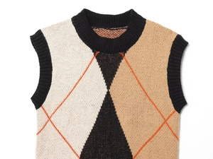 Close-up of argyle knit vest featuring black beige diamond pattern with orange stitching