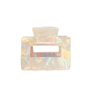 Iridescent rectangular acetate hair claw clip with minimalist cutout design on white background
