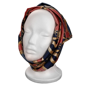 Elegant silk scarf with red and blue chain patterns displayed on a white model head