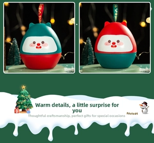 Detail view of festive round Christmas Eve apple gift boxes with cute faces and hanging ribbons