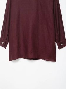 Detail view of burgundy linen blazer cuff with polished silver metallic buttons
