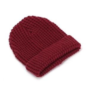 Detailed view of dark wine red knitted beanie with thick vertical ribbed texture