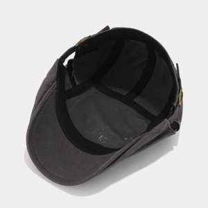 Detail view of the dark grey ivy cap showing interior lining and metal adjustment buckle
