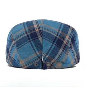 Detail of adjustable metal buckle on blue and brown plaid cotton ivy cap for men
