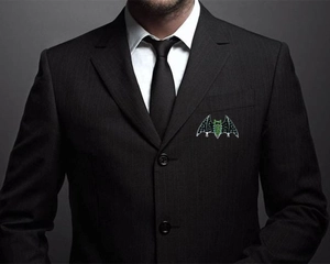 Macro view of crystal bat brooch with green and black rhinestones on a blazer lapel