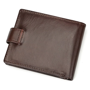 Detail of dark brown leather tri-fold wallet showing textured finish and buckle strap