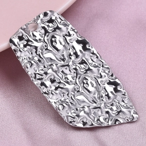 Macro shot of silver 304 stainless steel heart pendant with hammered texture and small hole