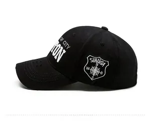 Detail view of black baseball cap with white embroidery and distressed brim edge