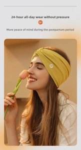 Close-up of yellow wide knotted postpartum headband worn by a model in a cozy setting