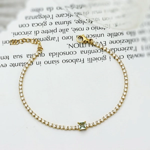 Elegant gold titanium bracelet featuring square blue gemstone and cubic zirconia accents