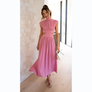 Sleeveless pink midi dress with high neck and waist cut-outs in modern indoor setting