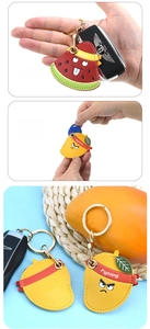 Leather fruit-shaped Airtag cases with watermelon and mango designs on keychains