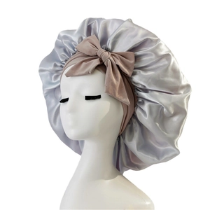 Silver satin sleep bonnet with a large pink bow, hair protection cap for long hair