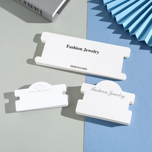 White kraft paper jewelry display cards with Fashion Jewelry print on a creative background