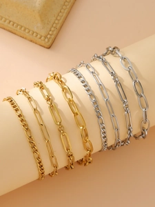 Close-up of 7-piece minimalist mixed gold and silver link bracelets on display stand