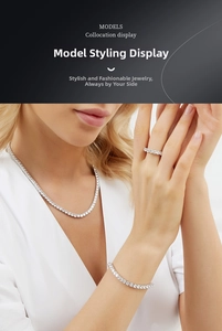 Close-up of 18K gold plated copper tennis necklace and bracelet set with round zircons