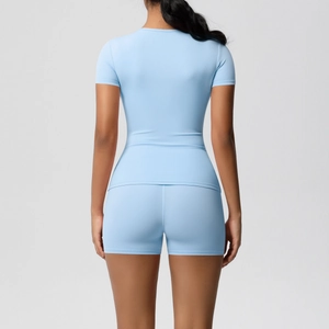Detail of light blue slim-fit sports t-shirt and high-waisted shorts set from back view