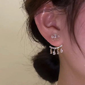 Elegant gold zircon flower stud earrings with cascading drop stones shown on model