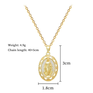 Detailed view of oval gold pendant featuring Virgin Mary relief with small crystals