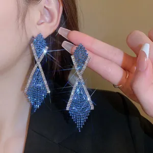 Elegant crisscross tassel earrings with deep blue rhinestones and white gemstones
