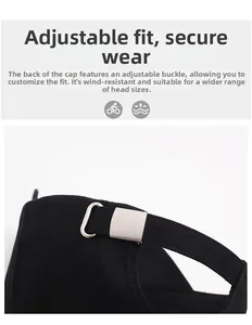 Close-up of adjustable matte silver metal buckle on a black twill cotton baseball cap