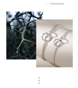 Macro detail of silver Mobius thorn bracelet featuring intricate metallic vine design