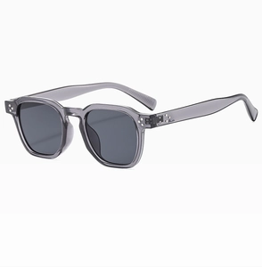 Detail view of transparent grey square frame sunglasses with silver hinge rivets