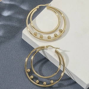 Women's gold titanium steel double hoop earrings with metal bead accents in minimalist style