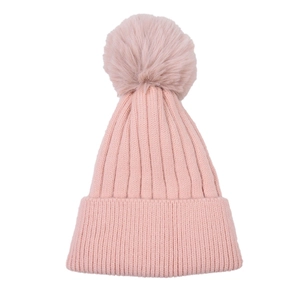 Detail of pink knitted winter hat featuring thick ribbed texture and a soft faux fur pom-pom