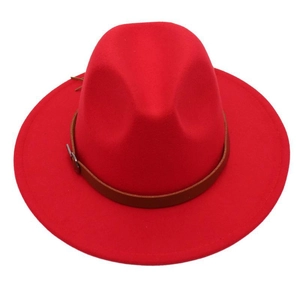 Detail of red wide brim fedora hat featuring a brown faux leather band and silver buckle