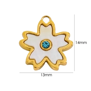 Detail view of 14K gold plated cherry blossom charm with white shell inlay, size 13x14mm