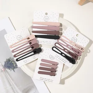 Detailed view of matte earth-toned hair clips in assorted shapes on display cards